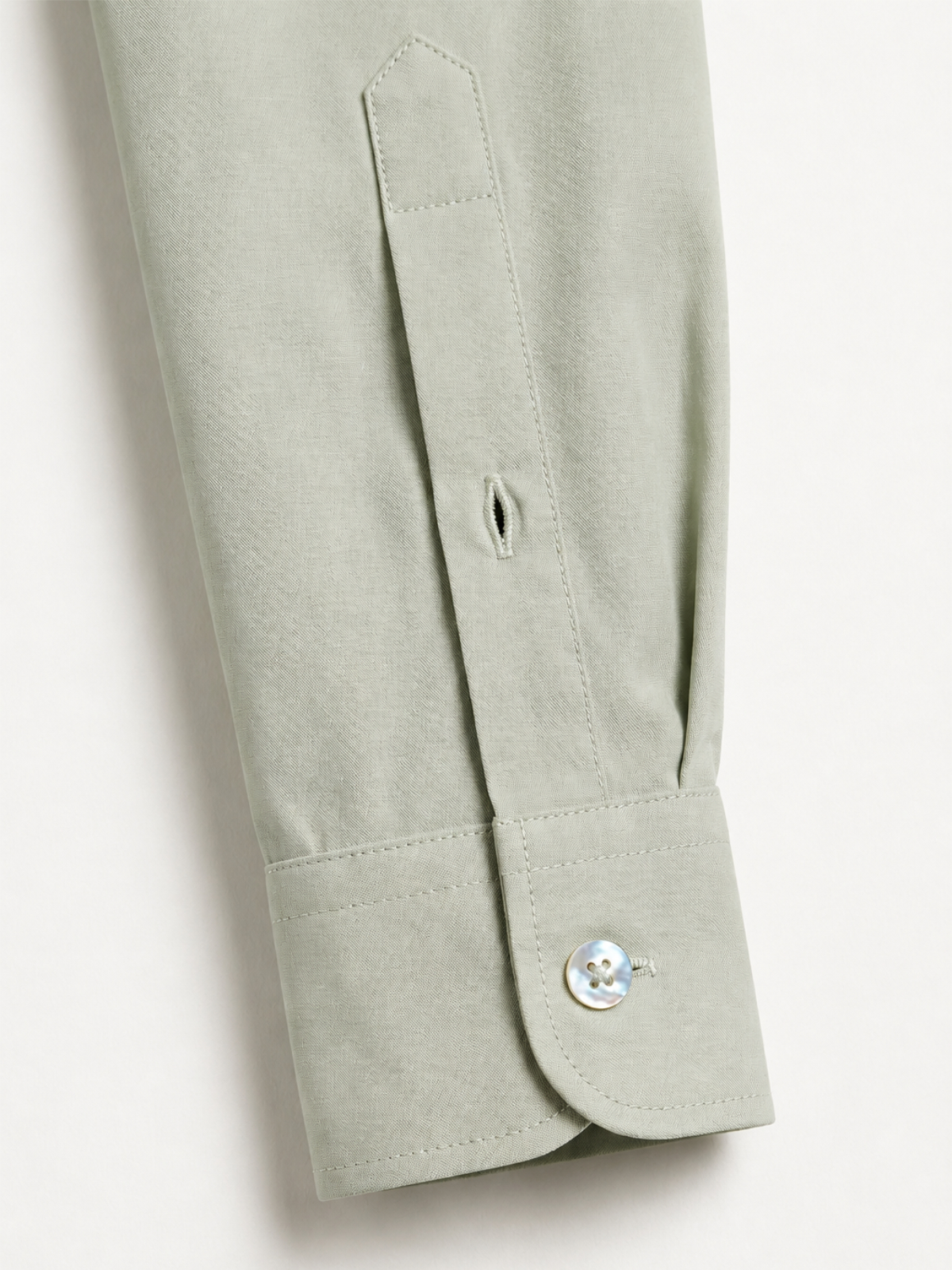 Sage green shirt sleeve cuff close up
